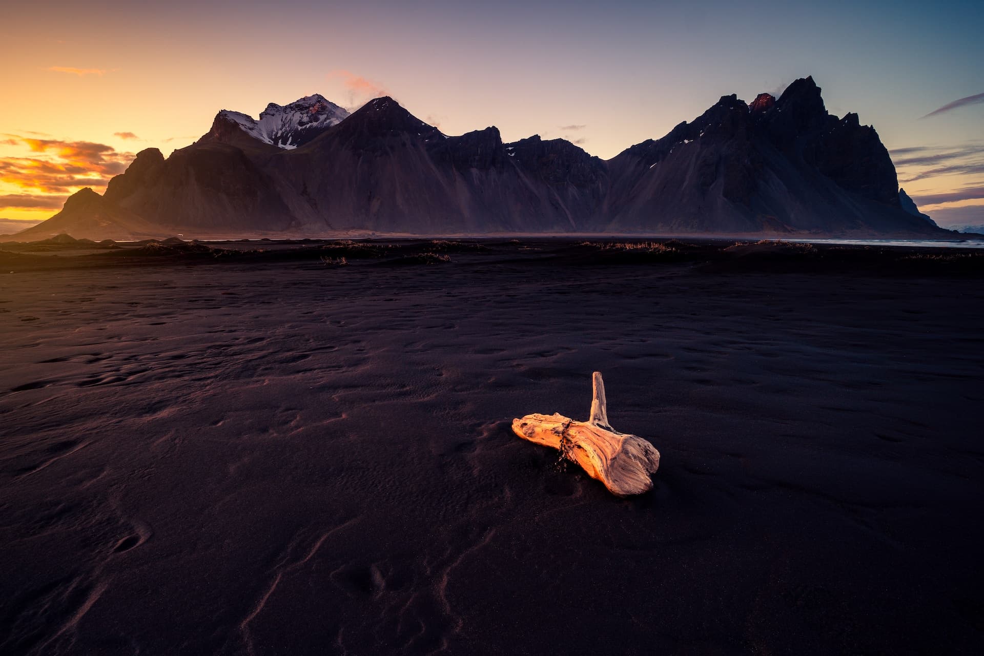 Mountain backdrop with a tree stump in the foreground